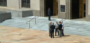 a group of men standing in front of a building
